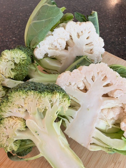 Cauliflower and broccoli on a chopping board