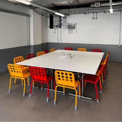 Meeting room with tables and chairs.