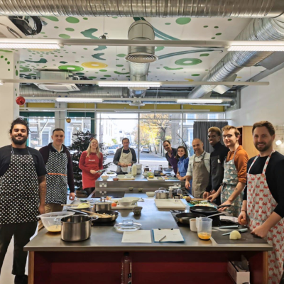 Training kitchen with people cooking food