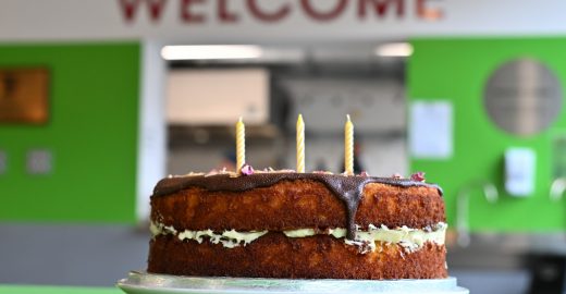 Birthday Cake in front of 'Welcome Sign'
