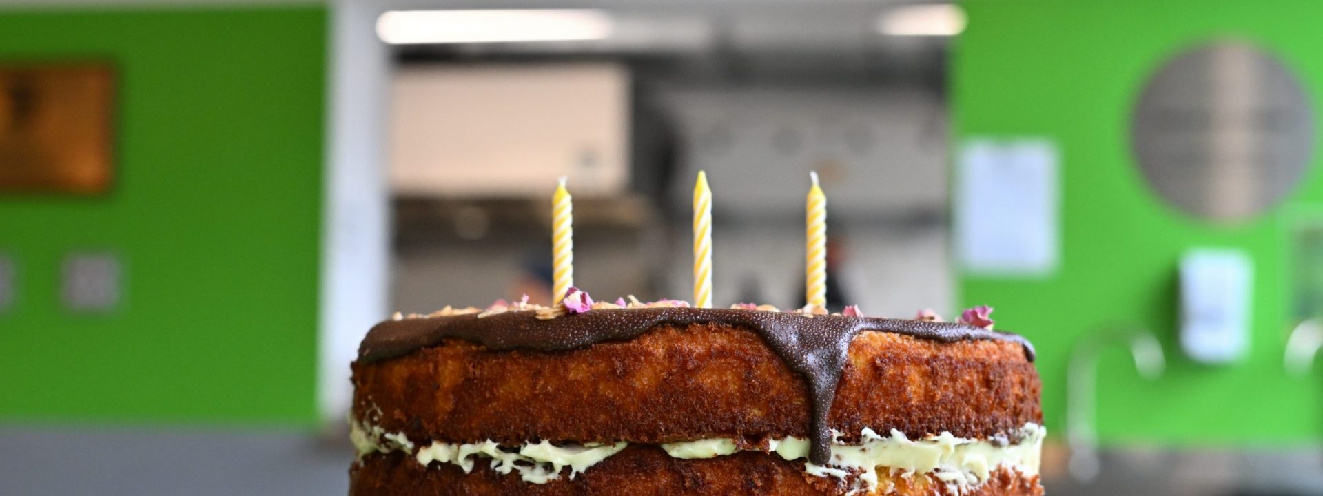 Birthday Cake in front of 'Welcome Sign'